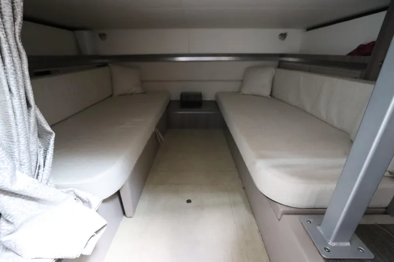 Slide: The Image of 2019 Sea Ray Sundancer 320 cabin interior with twin beds and neutral decor. - 38