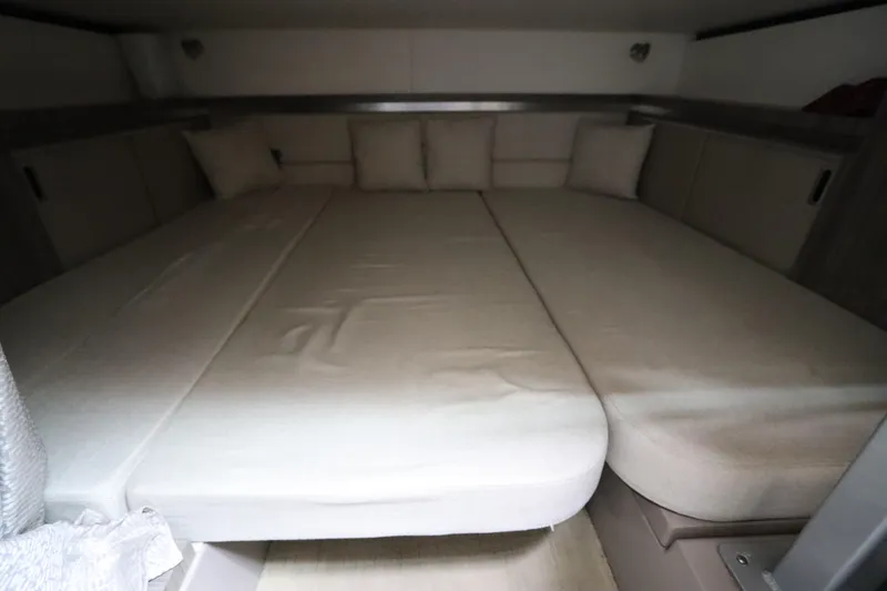 Slide: The Image of Interior cabin of 2019 Sea Ray Sundancer 320 with beige cushions and bedding. - 39