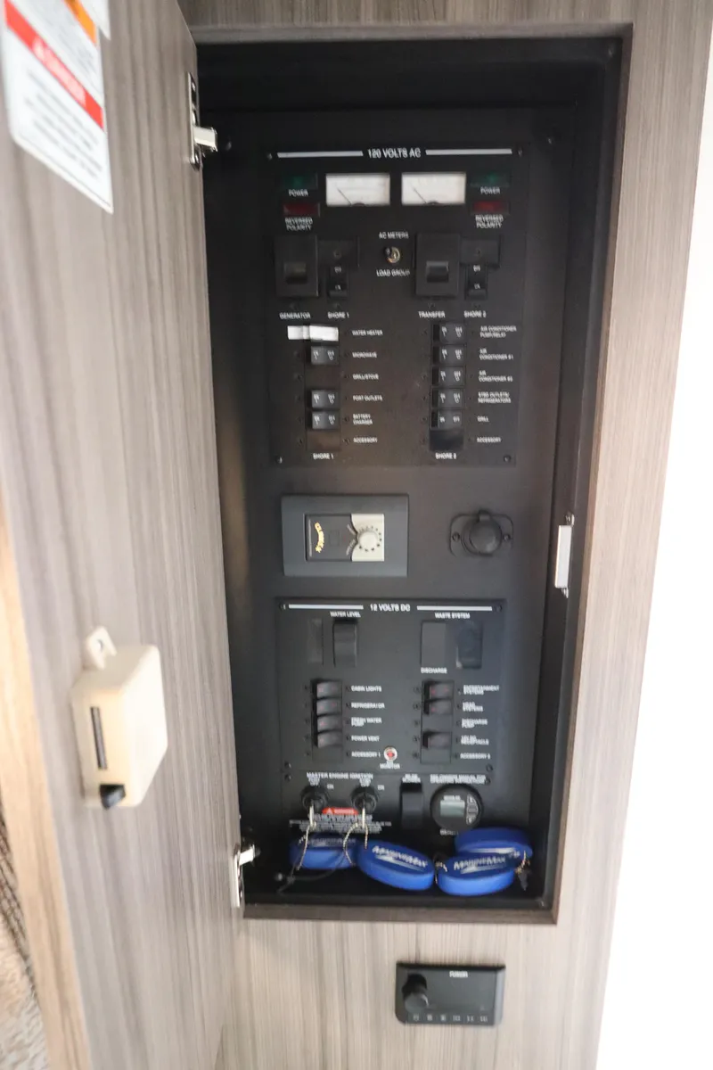 Slide: The Image of Electrical panel inside 2019 Sea Ray Sundancer 320 boat, featuring various switches and controls. - 42