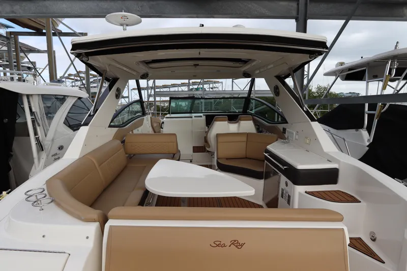 Slide: The Image of 2019 Sea Ray Sundancer 320 yacht interior with tan seating and modern amenities. - 8