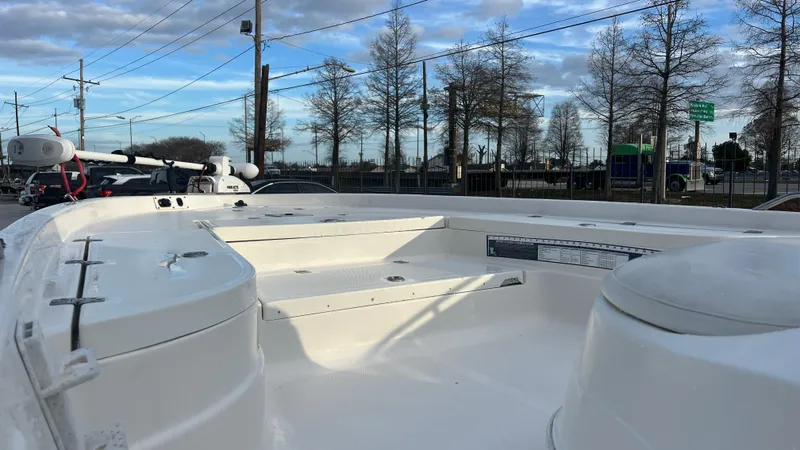 Slide: The Image of 2005 NauticStar 2200 boat deck with storage compartments and seating. - 12