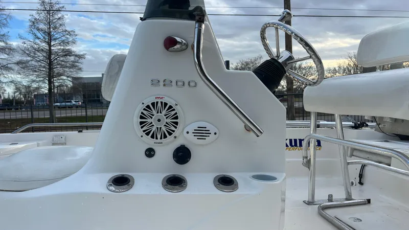 Slide: The Image of Close-up of 2005 NauticStar 2200 boat console with steering wheel and controls. - 13
