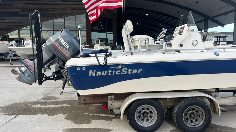 Slide: The Image of 2005 NauticStar 2200 boat on trailer with Yamaha outboard motor. - 4