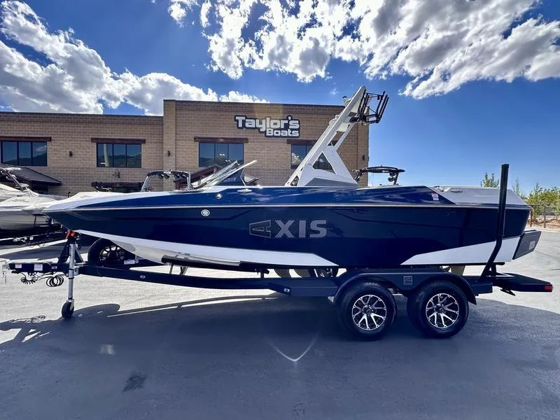 Slide: The Image of 2024 Axis A20 boat on trailer at Taylor's Boats dealership, under a partly cloudy sky. - 1