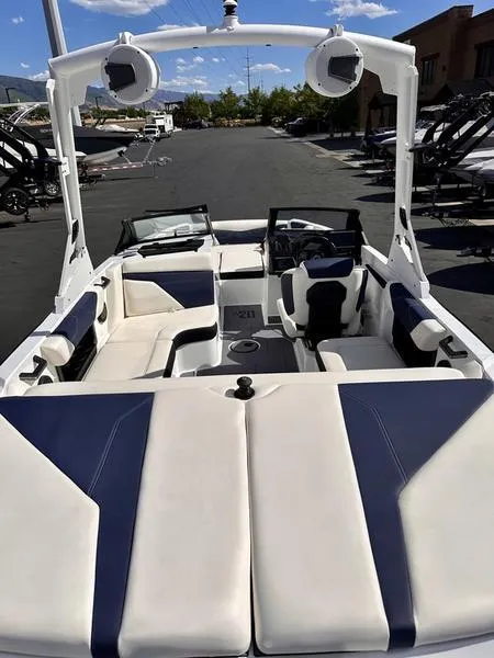 Slide: The Image of 2024 Axis A20 boat interior with white and navy seating, open-air design. - 10