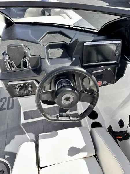 Slide: The Image of 2024 Axis A20 boat dashboard with steering wheel and modern controls. - 12