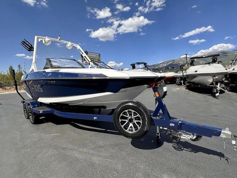 Slide: The Image of 2024 Axis A20 boat on trailer, parked outdoors under a clear blue sky. - 5
