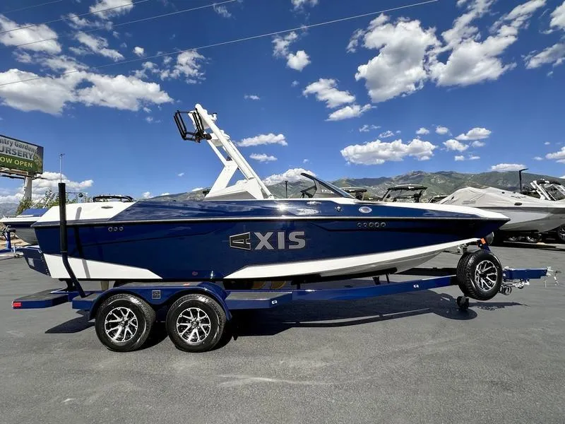Slide: The Image of 2024 Axis A20 boat on trailer under blue sky with clouds. - 6