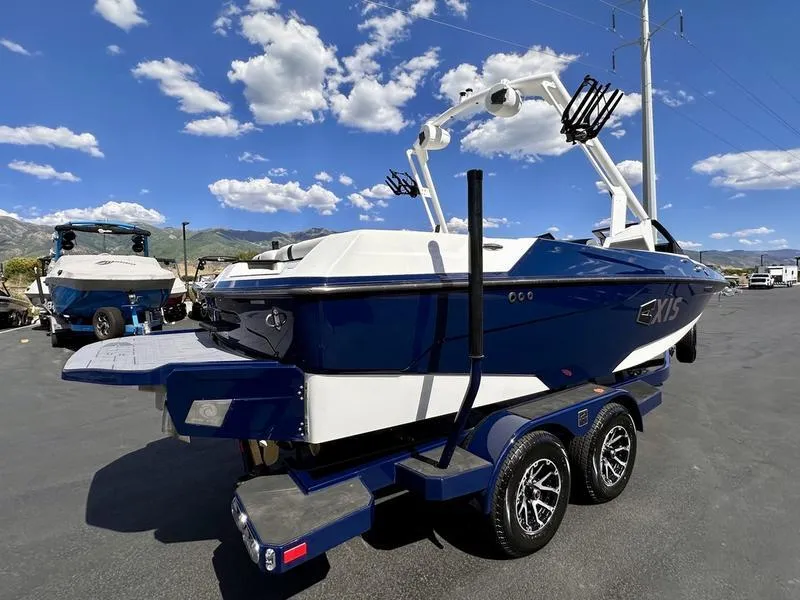 Slide: The Image of 2024 Axis A20 boat on trailer under blue sky with clouds. - 7
