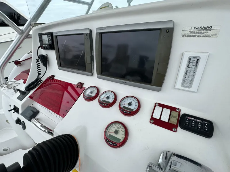 Slide: The Image of 2008 Donzi 38 ZSF boat dashboard with dual screens and gauges. - 25