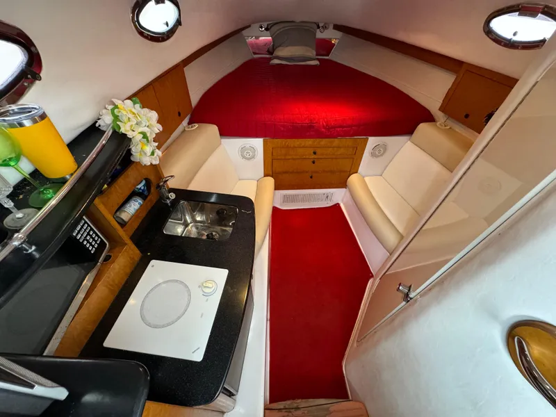 Slide: The Image of Interior of 2008 Donzi 38 ZSF boat with kitchenette and red bed. - 26