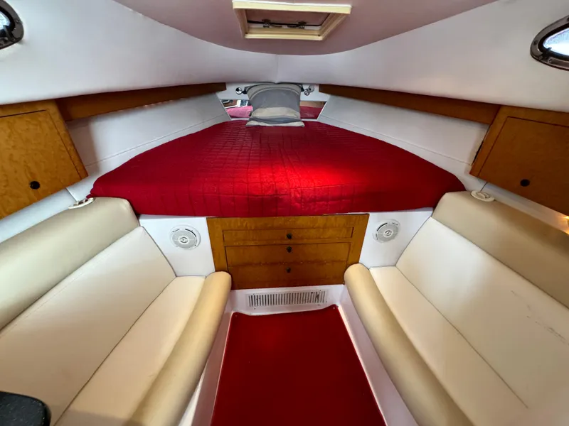 Slide: The Image of Interior cabin of a 2008 Donzi 38 ZSF boat with red bedding and beige seating. - 27