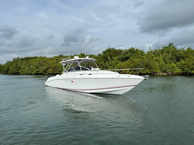 Slide: The Image of 2008 Donzi 38 ZSF boat cruising on a calm waterway. - 3