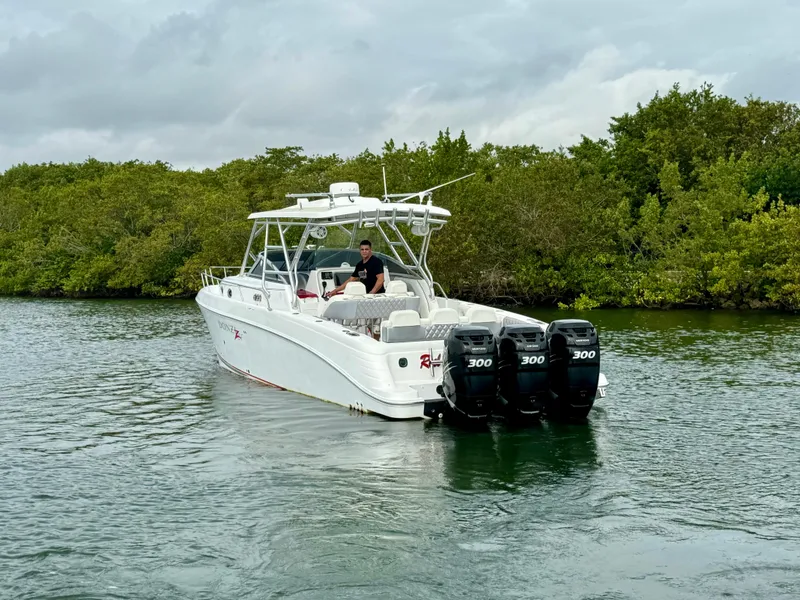 Slide: The Image of 2008 Donzi 38 ZSF boat with triple 300 HP engines on a calm waterway. - 6