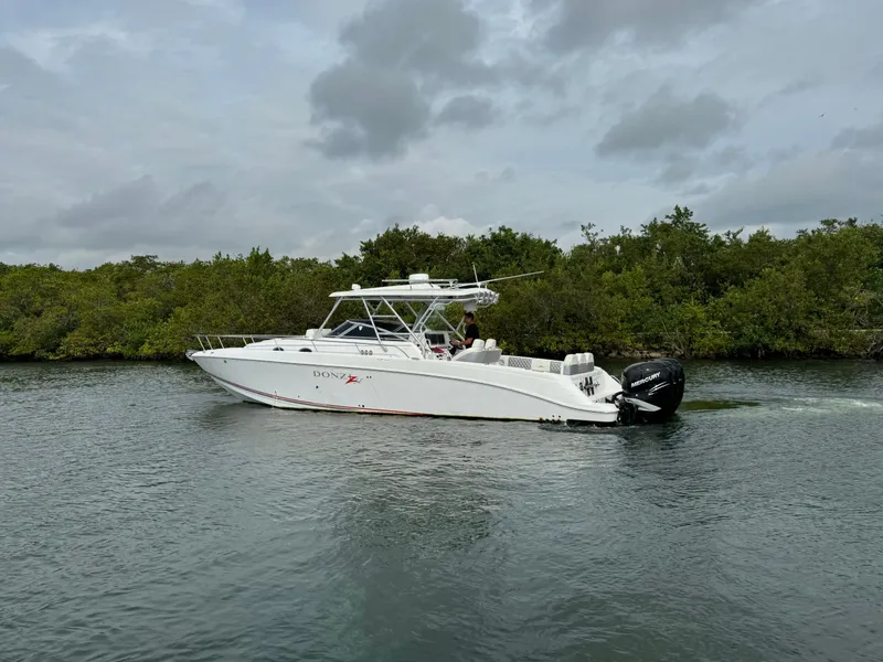 Slide: The Image of 2008 Donzi 38 ZSF boat cruising on a calm waterway. - 7