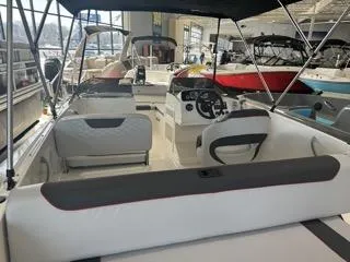 Slide: The Image of 2024 Bayliner Element M19 boat interior with seating and steering console. - 5
