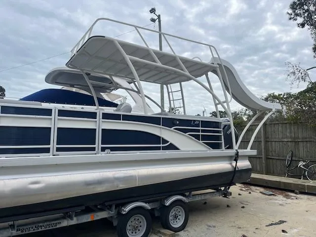 Slide: The Image of 2023 Bennington top deck pontoon boat with slide on trailer. - 2