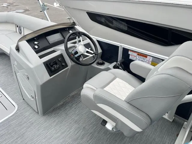 Slide: The Image of 2023 Bennington Top Deck boat interior with steering console and captain's chair. - 4