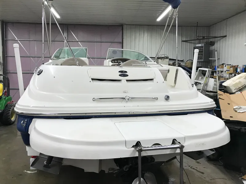 Slide: The Image of 2004 Sea Ray 240 Sundeck boat in a storage facility. - 10