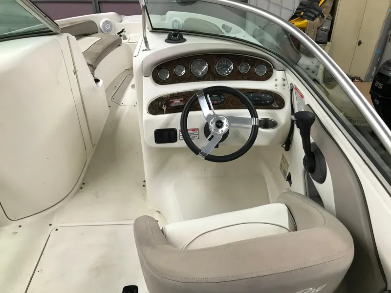 Slide: The Image of 2004 Sea Ray 240 Sundeck boat interior with steering wheel and dashboard. - 12