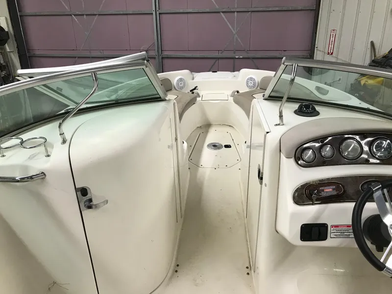 Slide: The Image of 2004 Sea Ray 240 Sundeck boat interior with dashboard and seating area. - 13