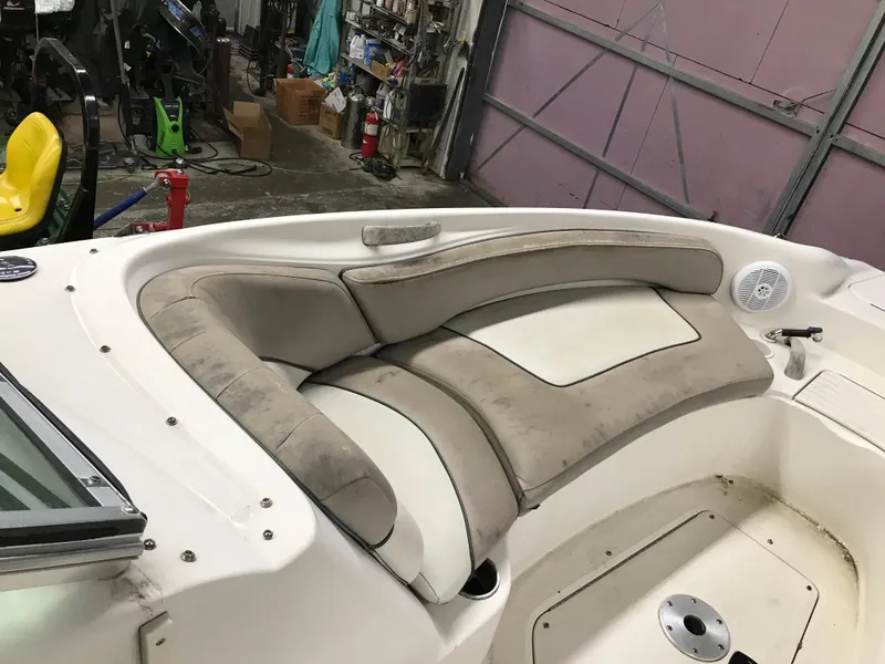 Slide: The Image of 2004 Sea Ray 240 Sundeck interior seating in a garage. - 17
