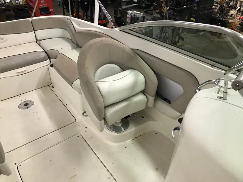 Slide: The Image of 2004 Sea Ray 240 Sundeck interior with beige and white seating. - 19