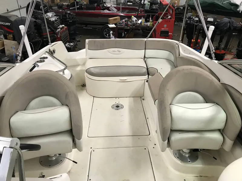 Slide: The Image of 2004 Sea Ray 240 Sundeck interior with seating and storage compartments. - 20