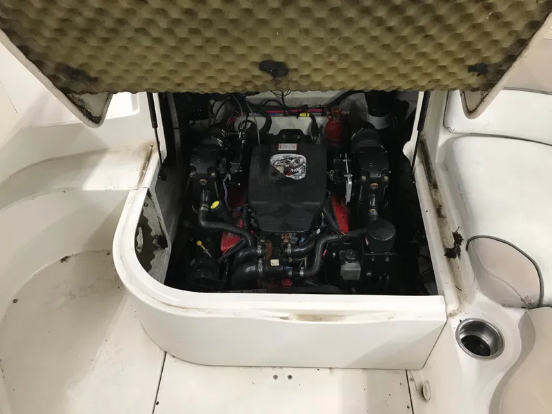 Slide: The Image of 2004 Sea Ray 240 Sundeck engine compartment with open hatch. - 21