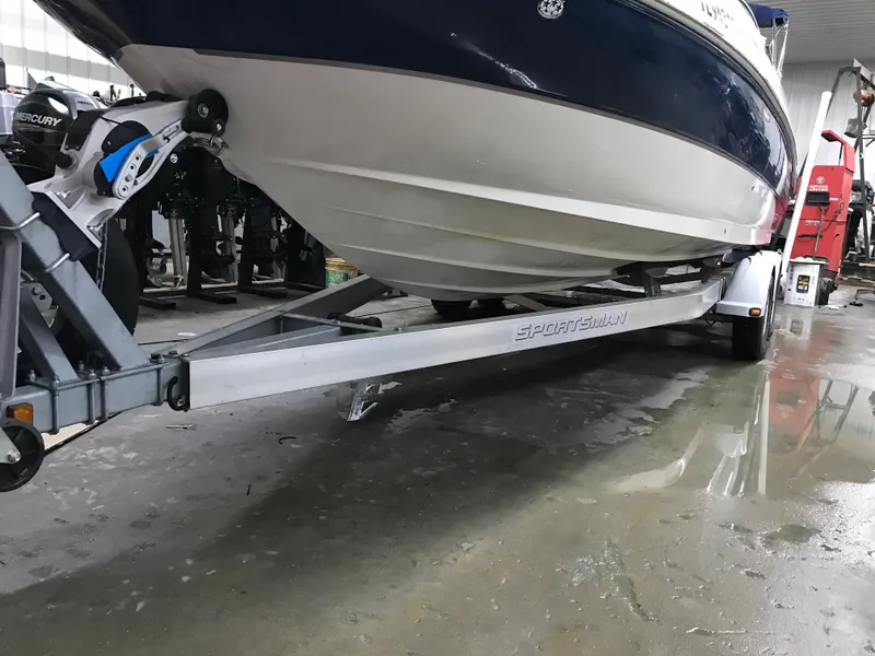 Slide: The Image of 2004 Sea Ray 240 Sundeck on a Sport Trail trailer in a garage. - 3
