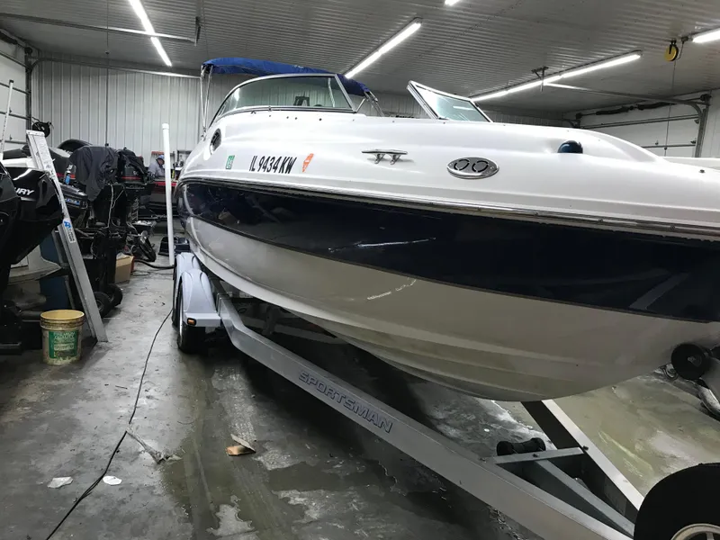 Slide: The Image of 2004 Sea Ray 240 Sundeck boat on trailer in a garage. - 6