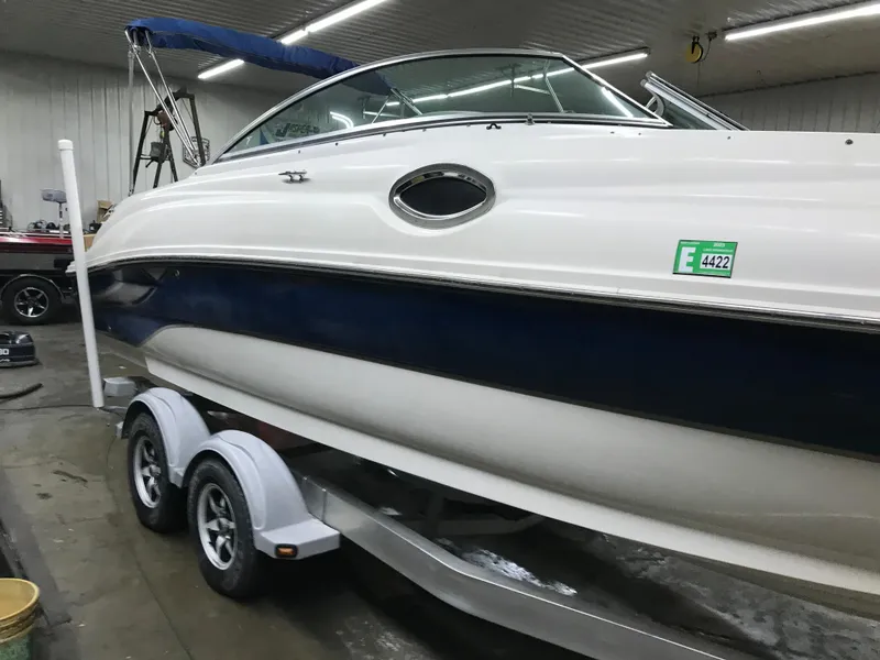 Slide: The Image of 2004 Sea Ray 240 Sundeck boat on a trailer in a garage. - 7