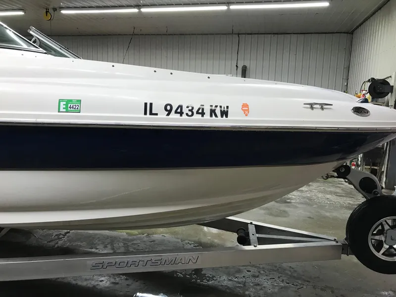 Slide: The Image of 2004 Sea Ray 240 Sundeck boat on a Sportsman trailer in a garage. - 8