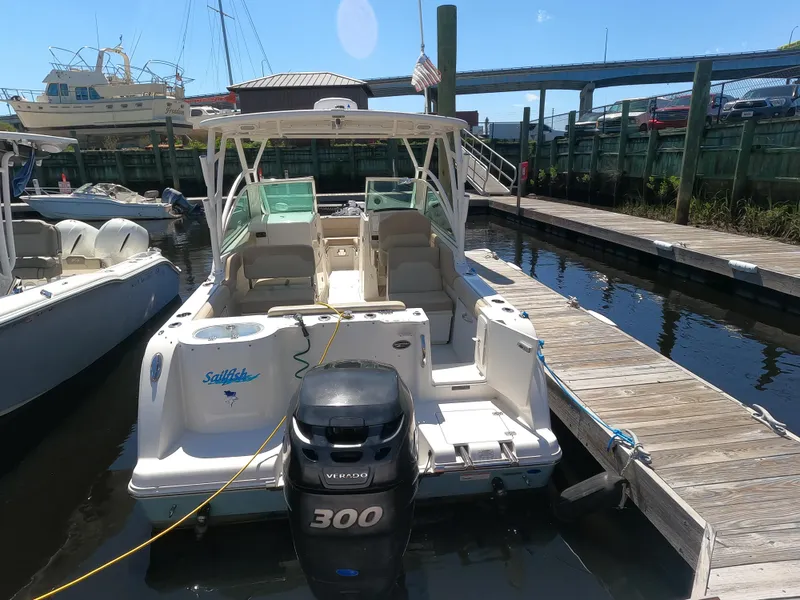 Slide: The Image of 2017 Sailfish 245 DC boat docked, featuring a powerful 300 HP Yamaha outboard motor. - 1