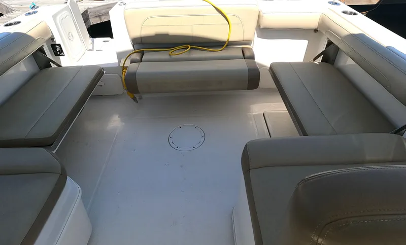 Slide: The Image of 2017 Sailfish 245 DC boat interior with cushioned seating and storage compartments. - 12
