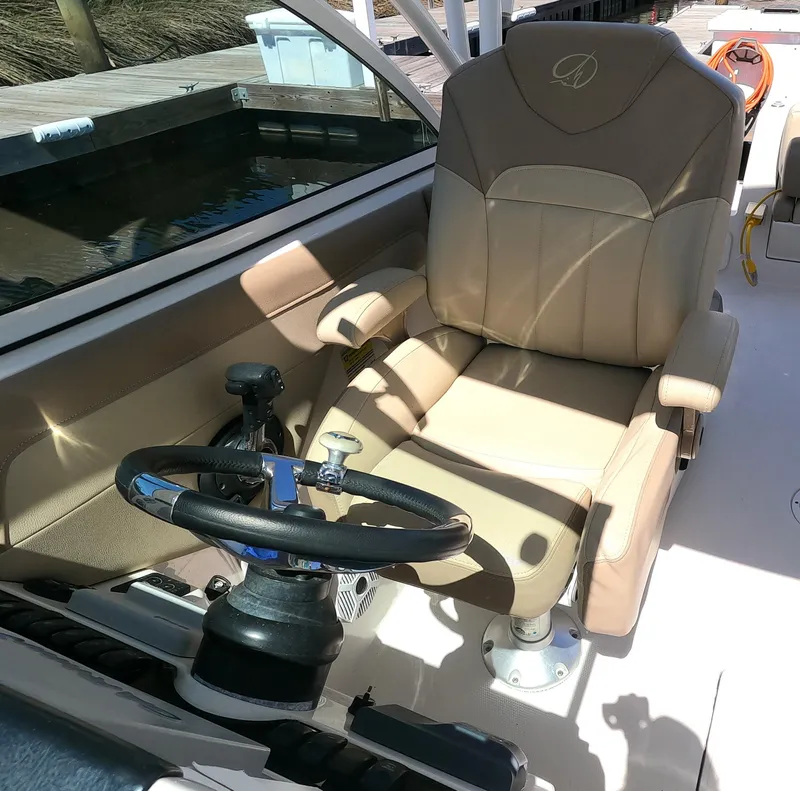 Slide: The Image of Captain's chair and steering wheel of a 2017 Sailfish 245 DC boat. - 13