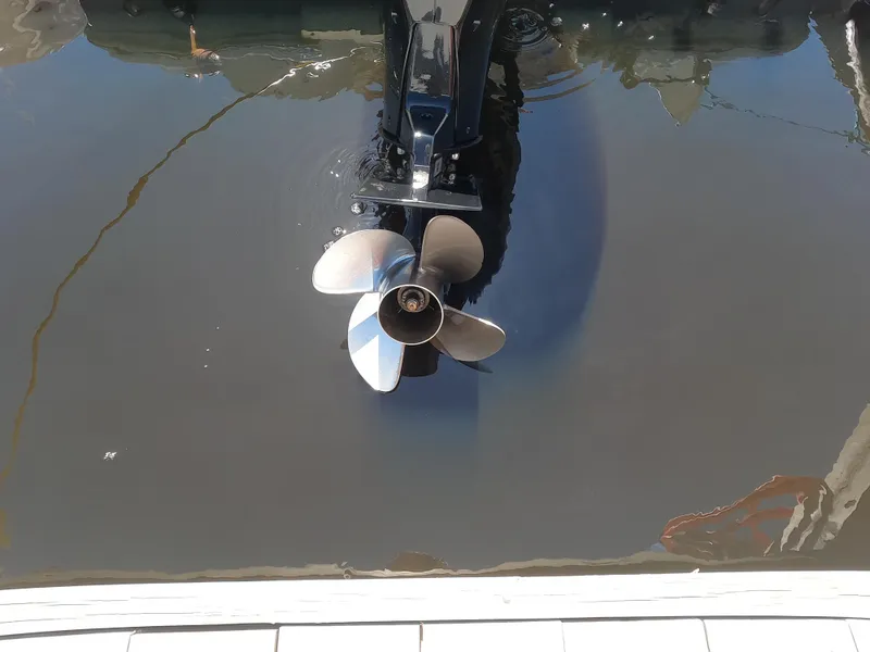 Slide: The Image of Outboard motor propeller of a 2017 Sailfish 245 DC boat in water. - 14