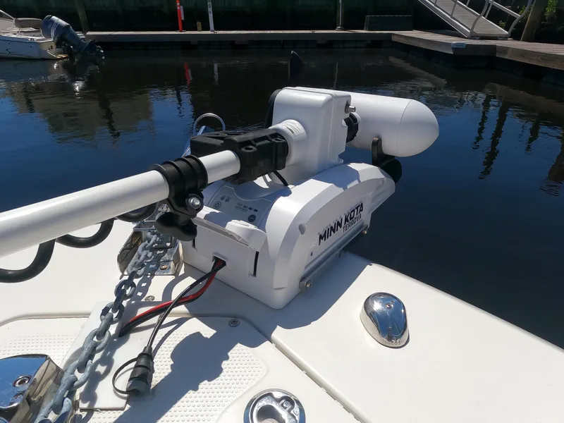 Slide: The Image of Minn Kota trolling motor on 2017 Sailfish 245 DC boat docked by the water. - 17