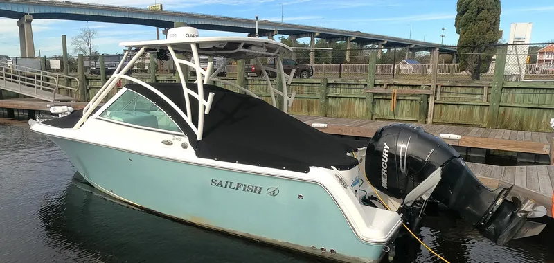 Slide: The Image of 2017 Sailfish 245 DC boat docked with Mercury outboard motor. - 19