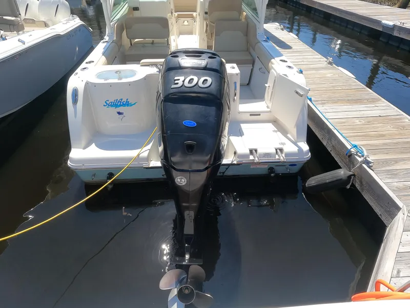 Slide: The Image of 2017 Sailfish 245 DC boat docked with 300 HP outboard motor. - 4