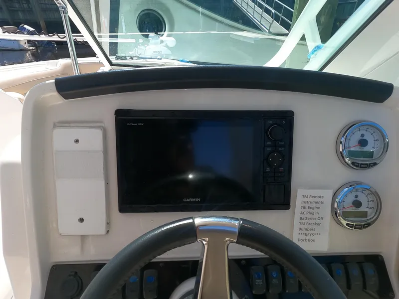 Slide: The Image of 2017 Sailfish 245 DC boat dashboard with Garmin GPS and gauges. - 6
