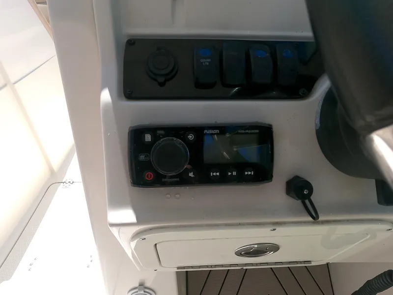 Slide: The Image of Control panel of a 2017 Sailfish 245 DC boat with Fusion stereo system. - 7