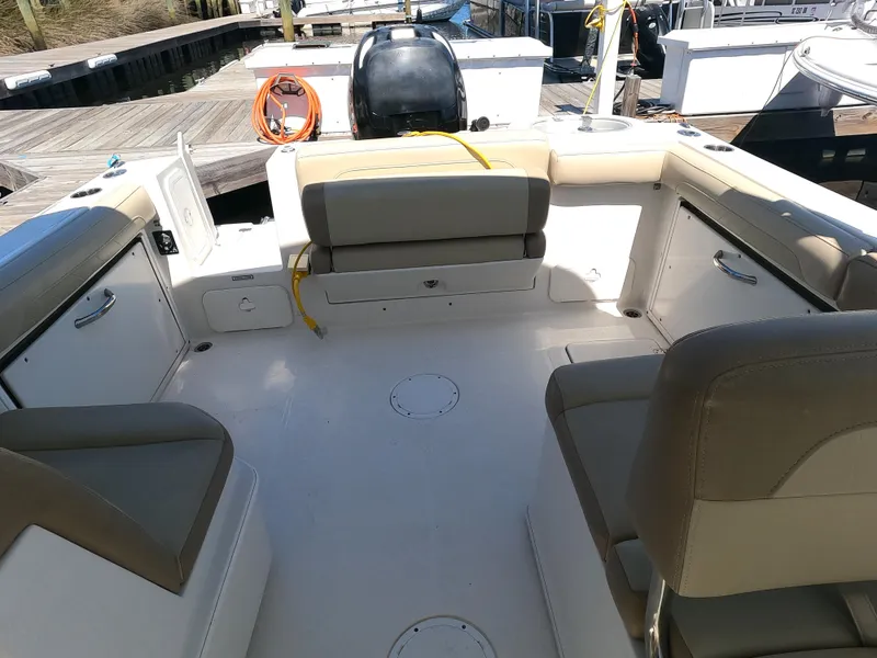 Slide: The Image of 2017 Sailfish 245 DC boat interior with seating and storage compartments. - 9