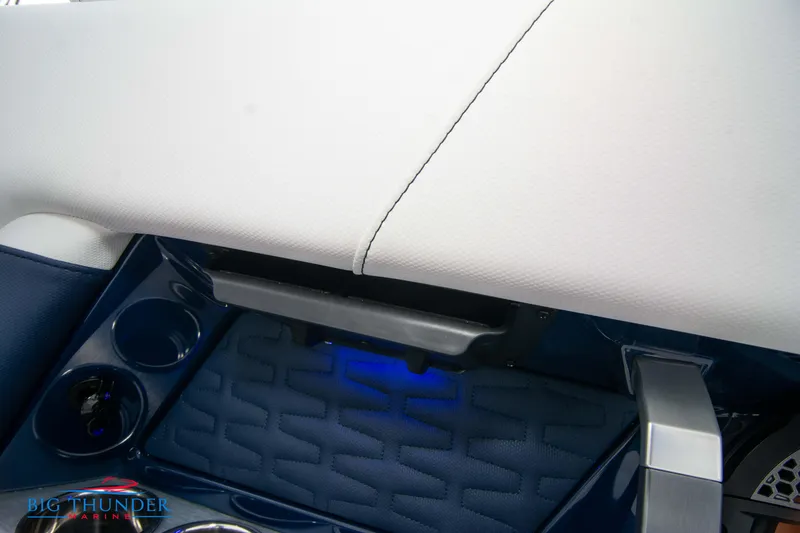 Slide: The Image of 2024 MasterCraft X22 boat interior with cup holders and storage compartment. - 21