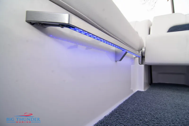 Slide: The Image of 2024 MasterCraft X22 boat interior with blue LED lighting and cushioned seating. - 22