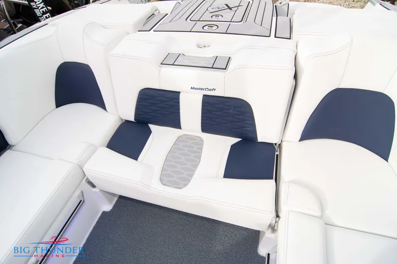 Slide: The Image of 2024 MasterCraft X22 boat interior with white and navy seating. - 23