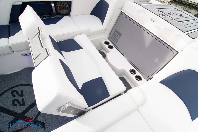 Slide: The Image of 2024 MasterCraft X22 boat interior with white and navy seating. - 24