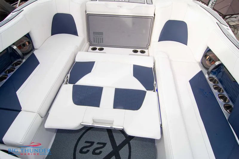 Slide: The Image of 2024 MasterCraft X22 boat interior with white and blue seating. - 25