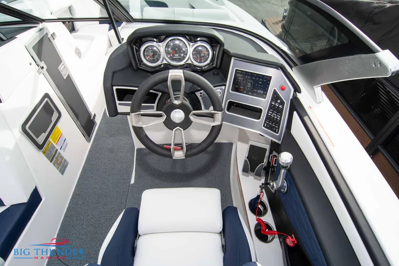 Slide: The Image of 2024 MasterCraft X22 boat cockpit with modern steering wheel and control panel. - 26