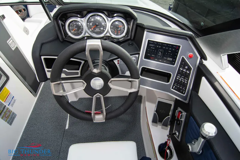 Slide: The Image of 2024 MasterCraft X22 boat dashboard with steering wheel, gauges, and control panel. - 27